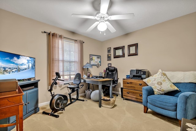 carpeted home office featuring ceiling fan