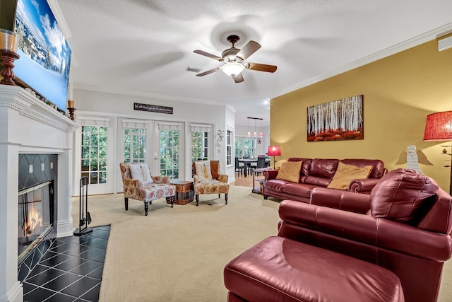 living room with a fireplace, a textured ceiling, and ornamental molding