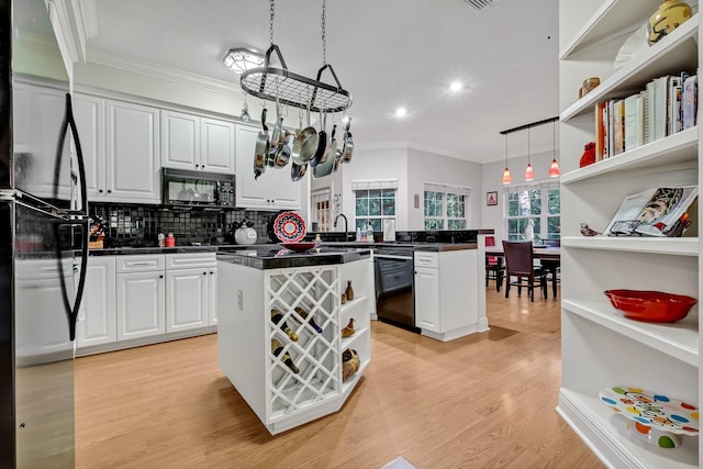 kitchen featuring black appliances, pendant lighting, white cabinets, and kitchen peninsula