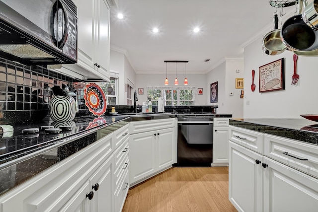 kitchen featuring white cabinetry, backsplash, light hardwood / wood-style floors, black appliances, and ornamental molding