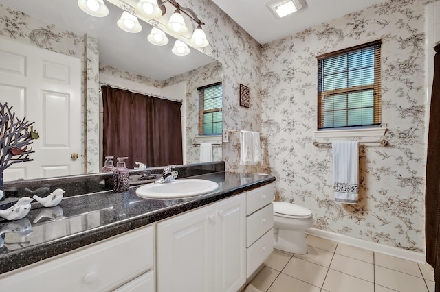 bathroom with tile patterned floors, vanity, and toilet