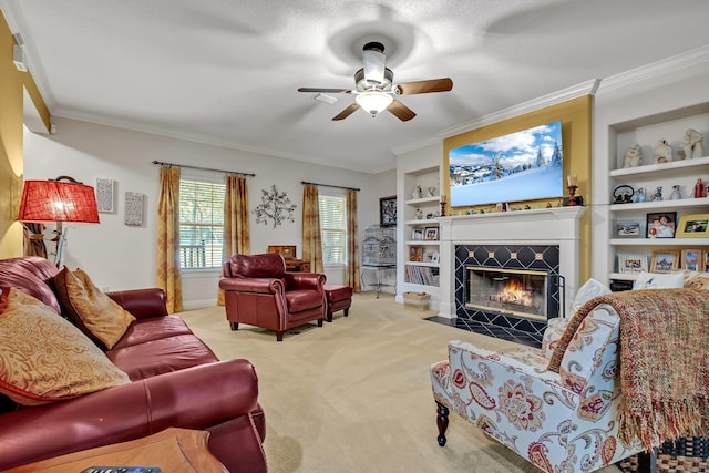 carpeted living room with a fireplace, built in features, ceiling fan, and ornamental molding