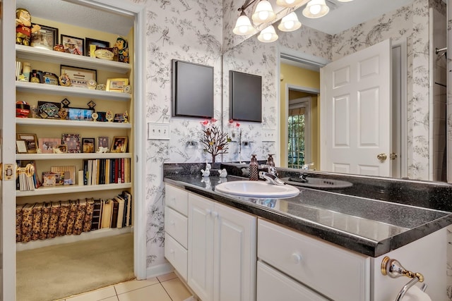 bathroom featuring a textured ceiling, vanity, and tile patterned floors