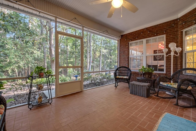 sunroom / solarium featuring ceiling fan