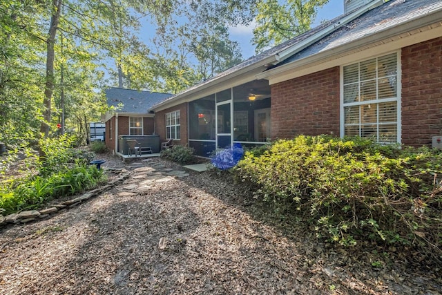 view of property exterior with a sunroom