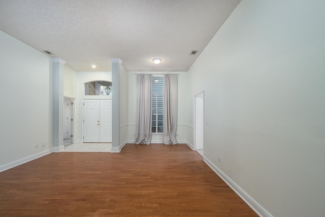 foyer entrance featuring light hardwood / wood-style floors and a textured ceiling