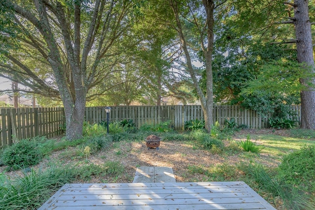 view of yard featuring a fire pit and a deck