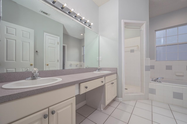 bathroom with vanity, tile patterned floors, separate shower and tub, and a textured ceiling