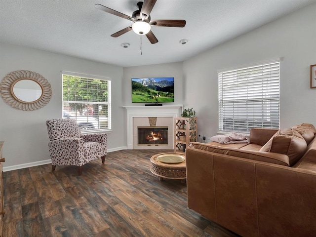 2490 Nugget Ln, Tallahassee, FL 32303 - living room featuring dark wood-style floors, ceiling fan, a fireplace, and baseboards