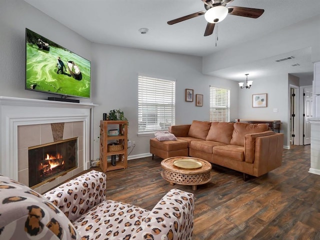 2490 Nugget Ln, Tallahassee, FL 32303 - living area featuring wood finished floors, a ceiling fan, a chandelier, and a tiled fireplace