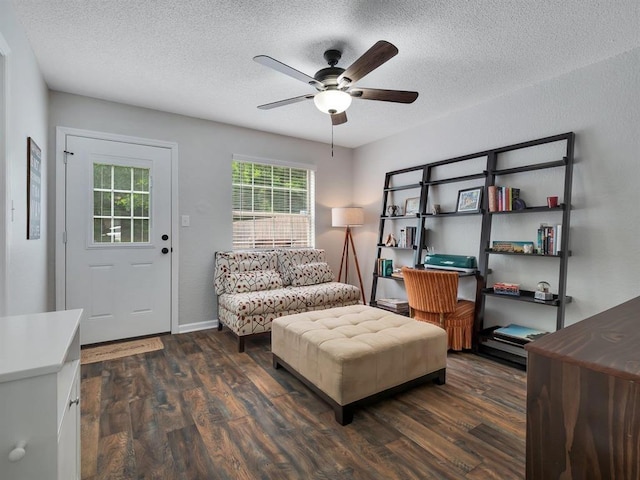 2490 Nugget Ln, Tallahassee, FL 32303 - living area with a textured ceiling, dark wood-style flooring, ceiling fan, and baseboards