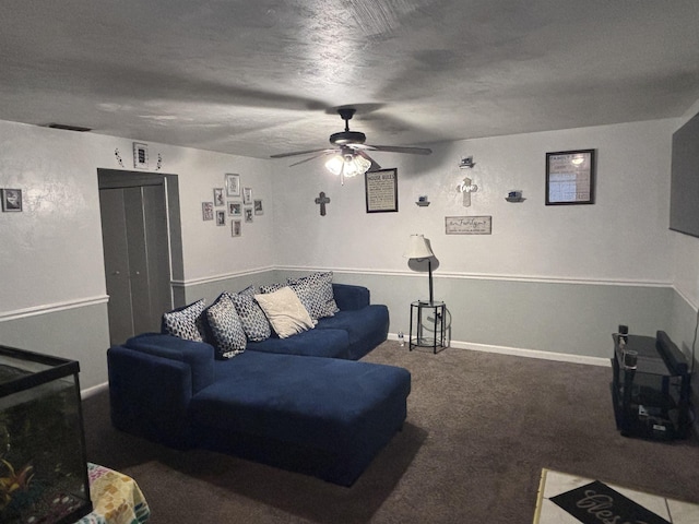 carpeted living area with a textured ceiling, a ceiling fan, and baseboards