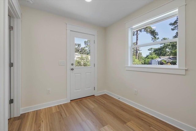 1602 Carruthers St, Tallahassee, FL 32308 - doorway to outside with baseboards and light wood finished floors
