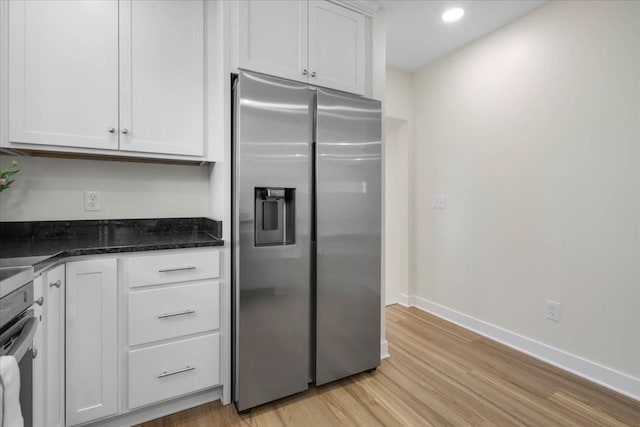 1602 Carruthers St, Tallahassee, FL 32308 - kitchen with stainless steel fridge, light wood-style flooring, white cabinets, baseboards, and recessed lighting