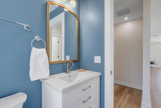 1602 Carruthers St, Tallahassee, FL 32308 - bathroom with vanity, wood finished floors, toilet, and recessed lighting