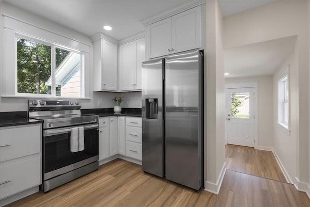 1602 Carruthers St, Tallahassee, FL 32308 - kitchen with appliances with stainless steel finishes, light wood-type flooring, dark countertops, white cabinets, and recessed lighting