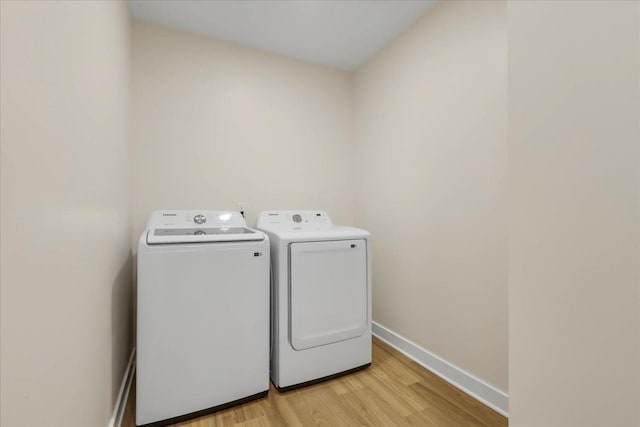1602 Carruthers St, Tallahassee, FL 32308 - washroom with washing machine and dryer, light wood-type flooring, and baseboards