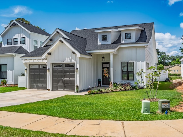 5717 Bascom Ln, Tallahassee, FL 32309 - modern farmhouse featuring board and batten siding, an attached garage, driveway, a front yard, and a shingled roof