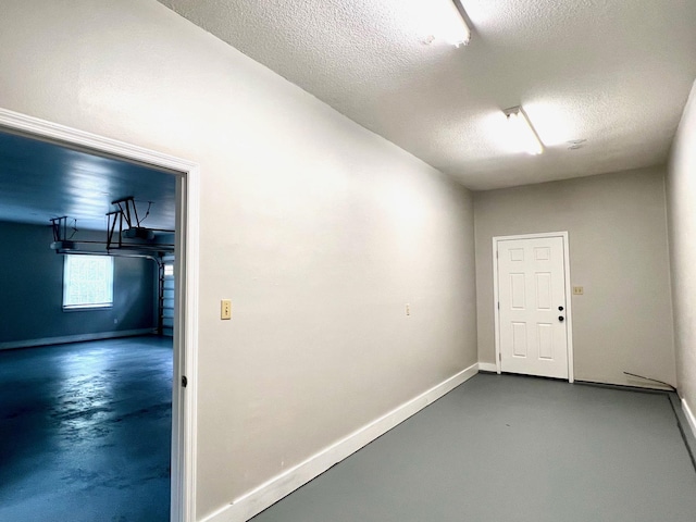 interior space featuring concrete flooring and a textured ceiling