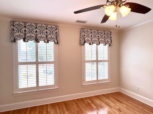 unfurnished room with crown molding, light hardwood / wood-style flooring, ceiling fan, and a healthy amount of sunlight