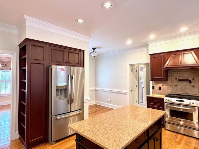 kitchen with light wood-type flooring, stainless steel appliances, tasteful backsplash, and ornamental molding