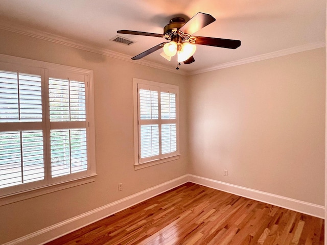 empty room with crown molding, ceiling fan, and hardwood / wood-style flooring