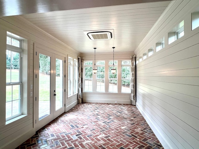 unfurnished sunroom featuring french doors, a wealth of natural light, and wooden ceiling