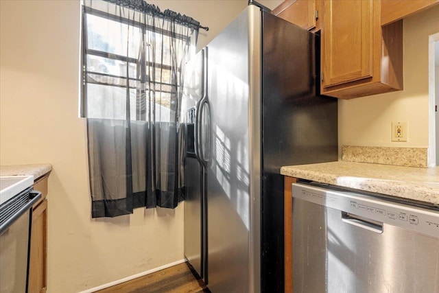 kitchen with stainless steel appliances and dark wood-type flooring