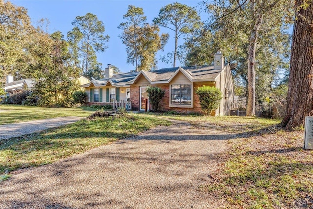 ranch-style home with a front lawn