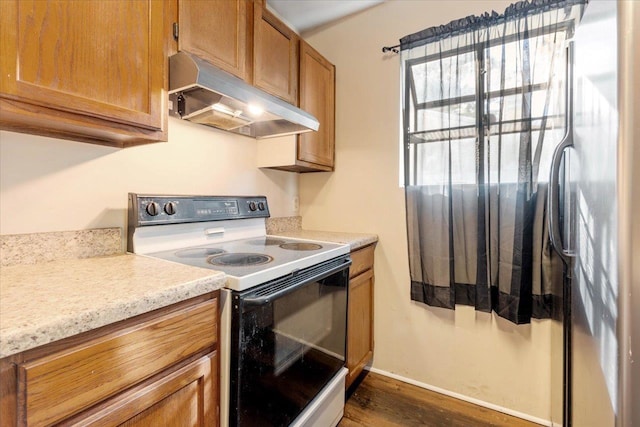 kitchen featuring white electric range, dark hardwood / wood-style flooring, and exhaust hood