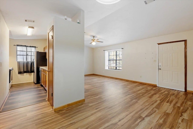 interior space with light hardwood / wood-style floors, vaulted ceiling, and ceiling fan