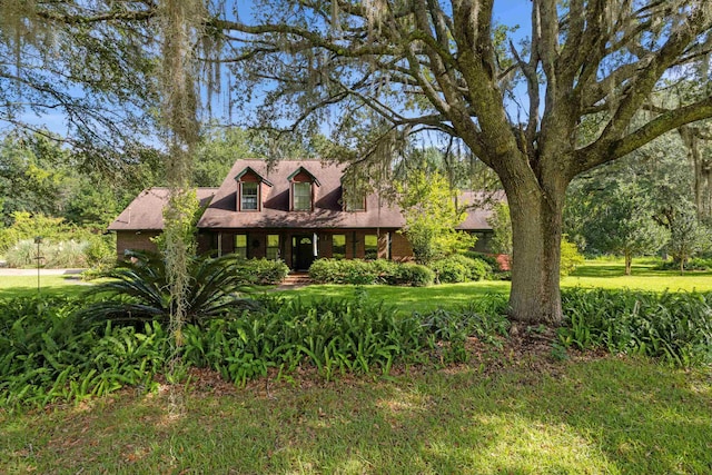 cape cod home with a front yard