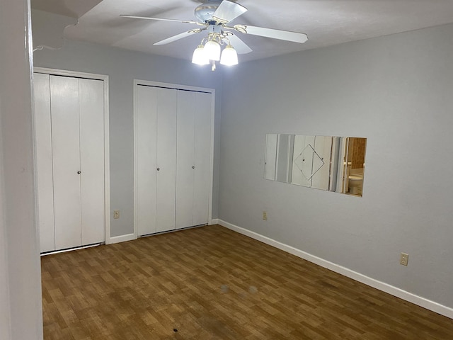 3722 Sutor Ct, Tallahassee, FL 32311 - unfurnished bedroom featuring multiple closets, wood finished floors, and a ceiling fan