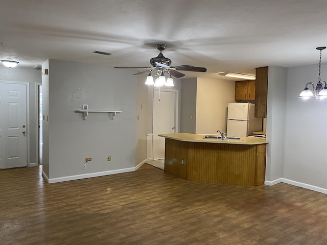 3722 Sutor Ct, Tallahassee, FL 32311 - kitchen featuring freestanding refrigerator, dark wood-style floors, light countertops, ceiling fan, and brown cabinets