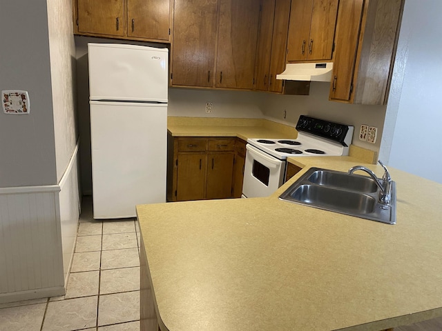 3722 Sutor Ct, Tallahassee, FL 32311 - kitchen with white appliances, under cabinet range hood, light countertops, and a peninsula