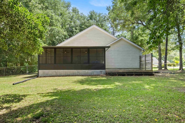 3224 Lord Murphy Trl, Tallahassee, FL 32309 - back of property featuring a sunroom, a yard, and fence