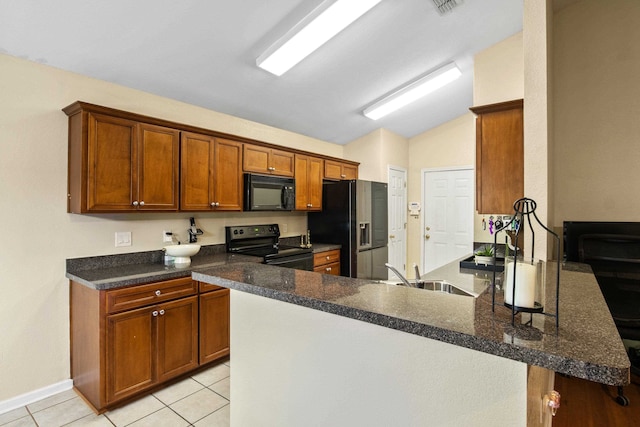 3224 Lord Murphy Trl, Tallahassee, FL 32309 - kitchen featuring lofted ceiling, brown cabinetry, a sink, a peninsula, and black appliances