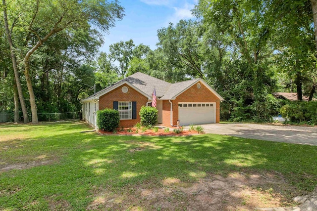 3224 Lord Murphy Trl, Tallahassee, FL 32309 - view of front of house featuring an attached garage, fence, a front lawn, brick siding, and driveway