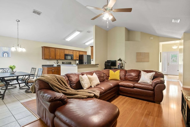 3224 Lord Murphy Trl, Tallahassee, FL 32309 - living area featuring lofted ceiling, visible vents, and ceiling fan with notable chandelier