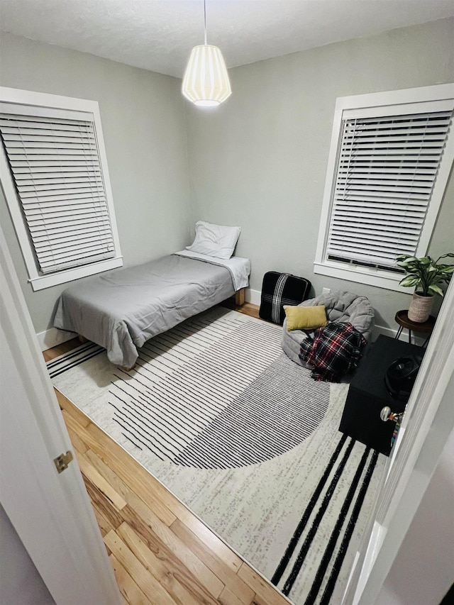 bedroom with hardwood / wood-style flooring