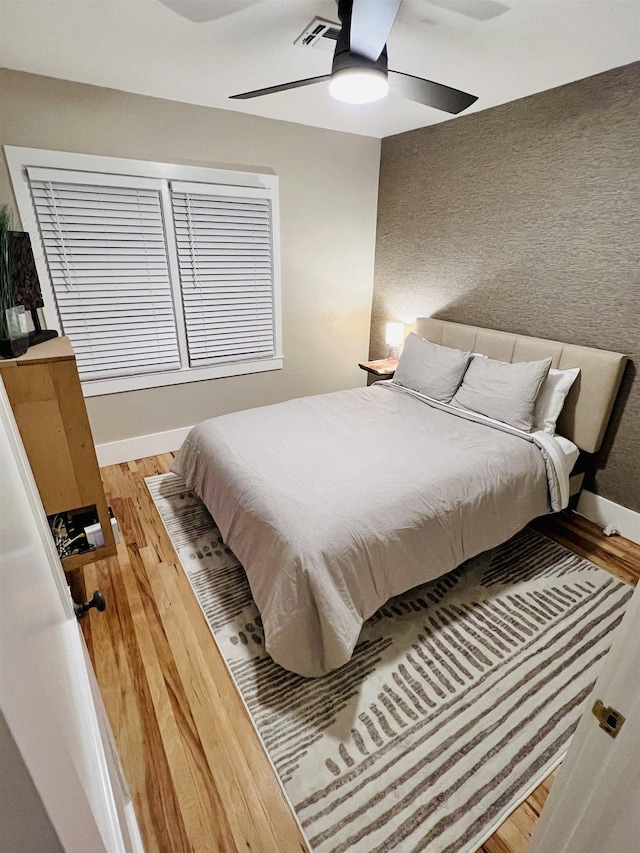 bedroom featuring ceiling fan and wood-type flooring