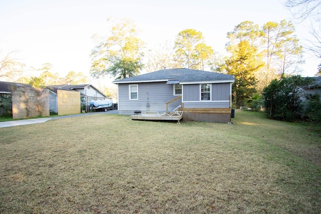 back of house with a yard and a wooden deck