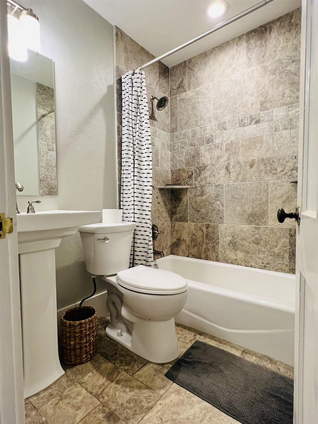 bathroom featuring shower / bath combination with curtain and toilet