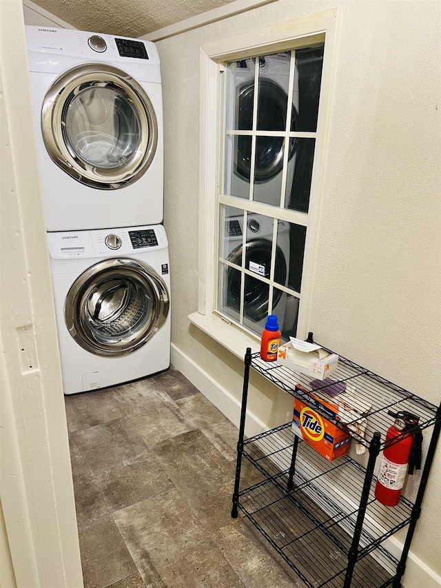 laundry area featuring stacked washer / dryer