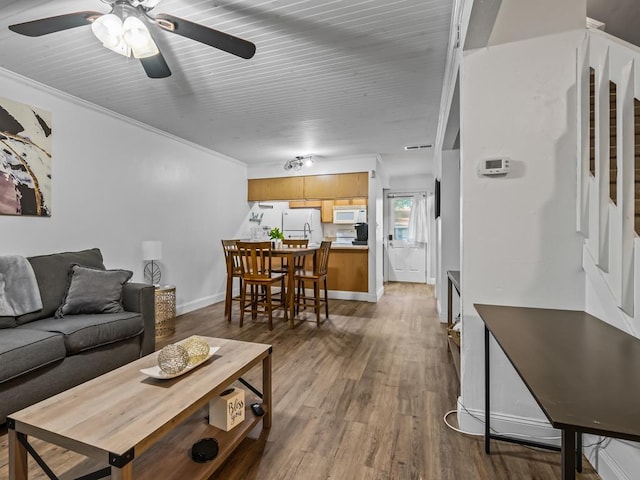 2271 Green Timbers Trl Unit B, Tallahassee, FL 32304 - living area with wood finished floors, ceiling fan, stairway, and crown molding