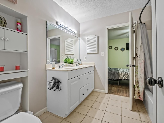 2271 Green Timbers Trl Unit B, Tallahassee, FL 32304 - ensuite bathroom with a textured ceiling, double vanity, tile patterned floors, and shower / bath combo