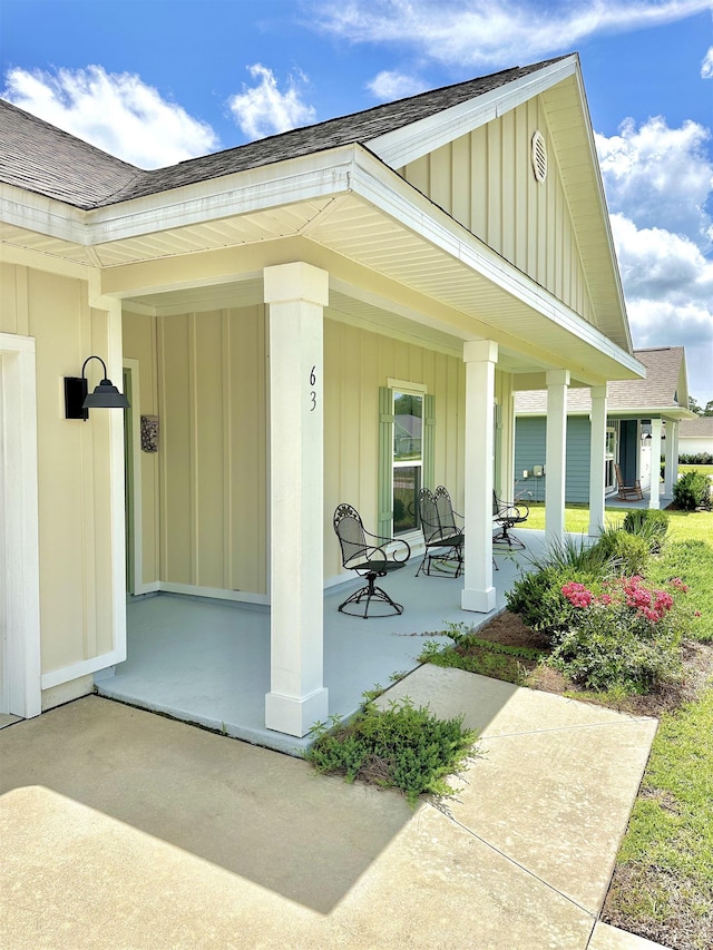 63 Windsor Way, Crawfordville, FL 32327 - entrance to property with board and batten siding, a porch, and a shingled roof