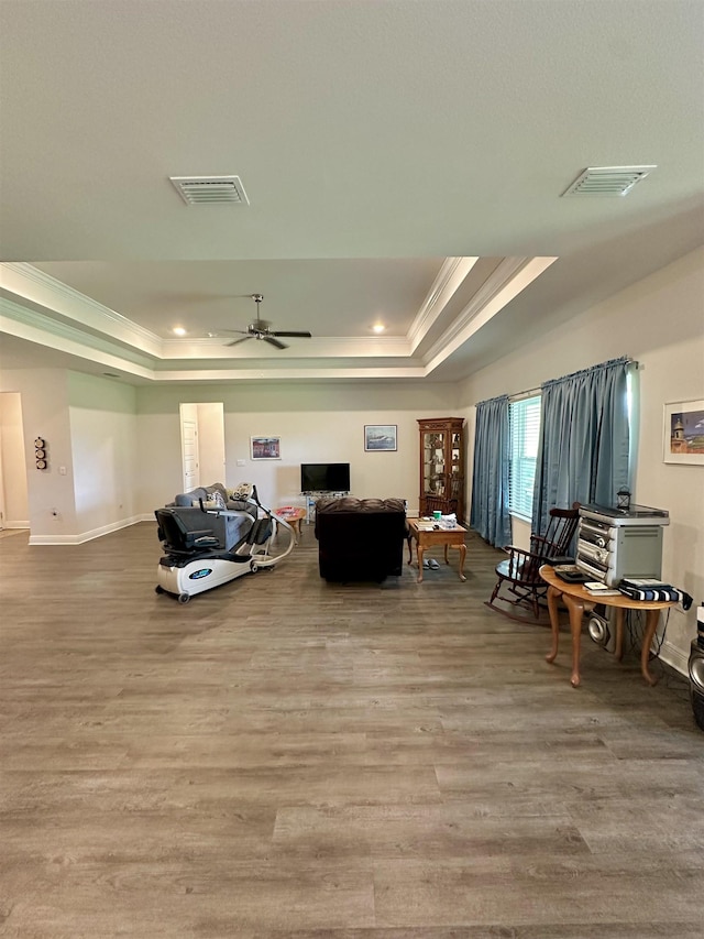 63 Windsor Way, Crawfordville, FL 32327 - living area featuring a tray ceiling, crown molding, wood finished floors, a ceiling fan, and recessed lighting