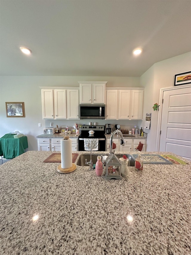 63 Windsor Way, Crawfordville, FL 32327 - kitchen featuring appliances with stainless steel finishes, light stone counters, white cabinetry, and recessed lighting