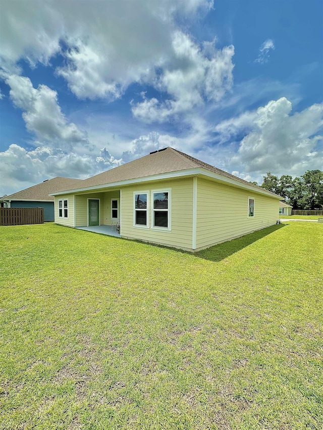 63 Windsor Way, Crawfordville, FL 32327 - rear view of house featuring a lawn and a patio